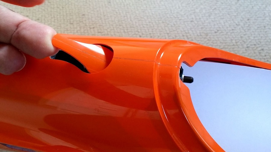 Second action, pulling up the latch cover at the rear
